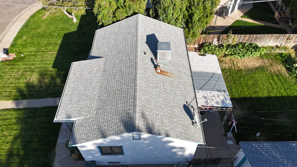 Professional roofing contractor performing a roof inspection on a Pueblo, Colorado home to check for storm damage, missing shingles, and winter readiness.