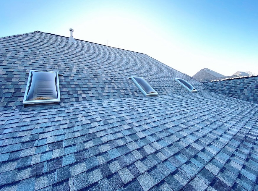 Residential asphalt shingle roof installation with skylights on a home in Southern Colorado completed by Patriot Roofing.